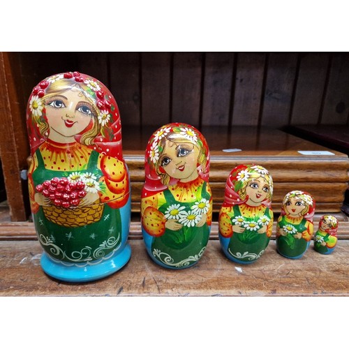 57 - A collection of Russian dolls, some being from the Semenov factory circa 1970s and one hand painted ... 