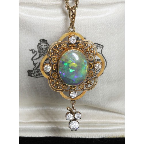 3 - An antique black opal and diamond pendant, the central millegrain set opal cabochon measuring approx... 