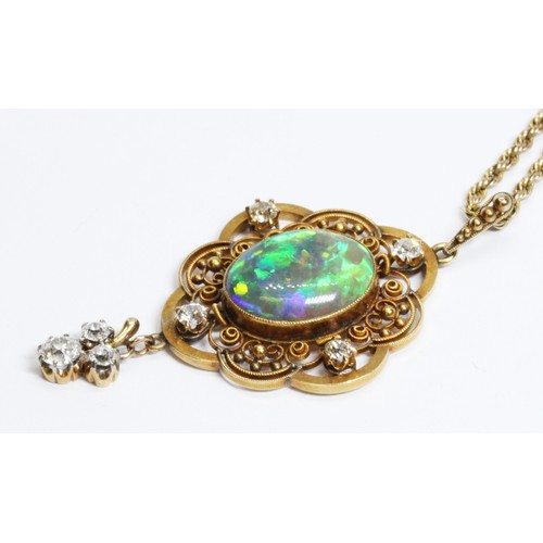 3 - An antique black opal and diamond pendant, the central millegrain set opal cabochon measuring approx... 