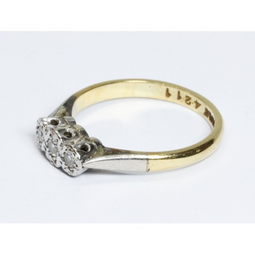 64 - A three stone diamond ring, band marked '18ct', gross weight 2.9g, size L.