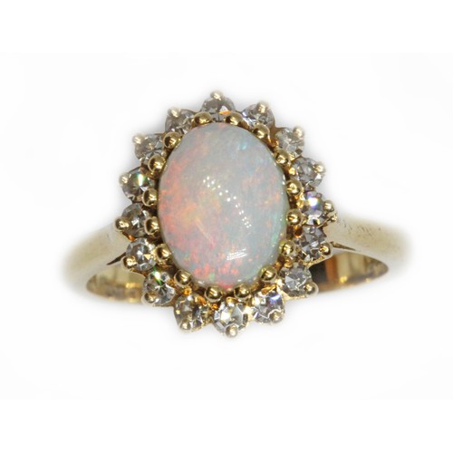 62 - An 18ct gold opal and diamond ring, the central opal cabochon measuring approximately 9.2mm x 7mm, d... 