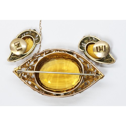 5 - A suite of citrine set jewellery, the marquise shaped brooch with impressive central oval cut orangi... 