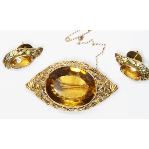 5 - A suite of citrine set jewellery, the marquise shaped brooch with impressive central oval cut orangi... 