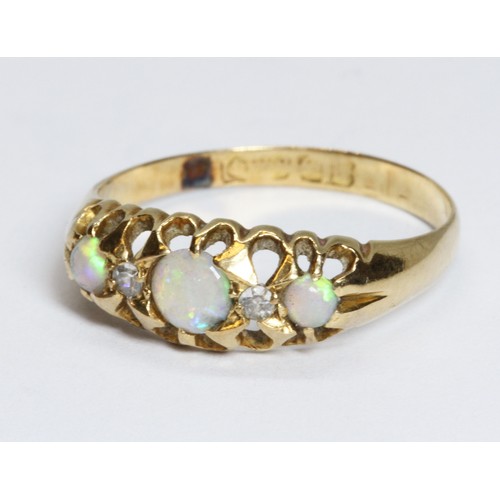 63 - An opal cabochon and diamond ring, hallmarked rubbed, gross weight 1.6g, size L.