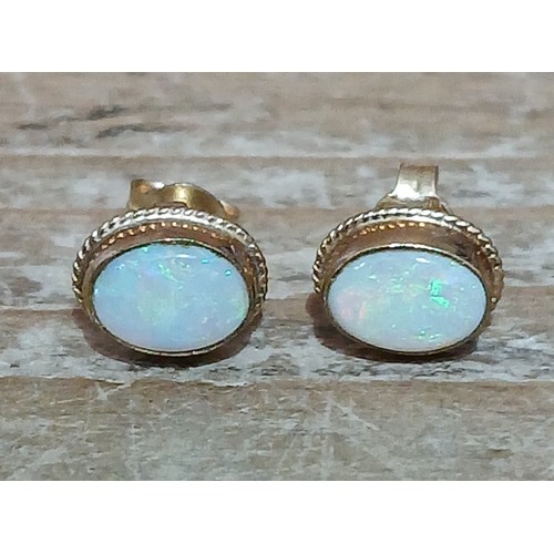 455 - A pair of hallmarked 9ct gold opal cabochon stud earrings, gross weight 1g.