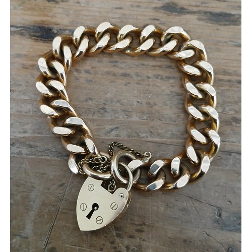 452 - A hallmarked 9ct gold curb link bracelet with heart shaped padlock clasp, length 16cm, weight 56.9g.