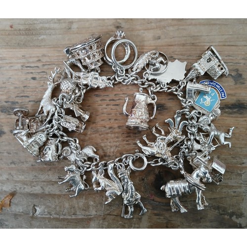 450 - A hallmarked silver charm bracelet, length 16cm, gross weight 91g.