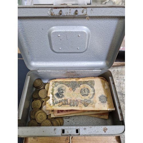 435 - A lock box of assorted tokens & world banknotes.