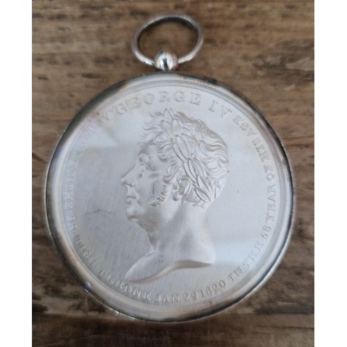 477 - A George IV white metal coronation medal in silver mount, 1821.