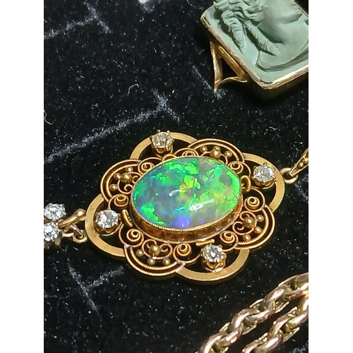 3 - An antique black opal and diamond pendant, the central millegrain set opal cabochon measuring approx... 