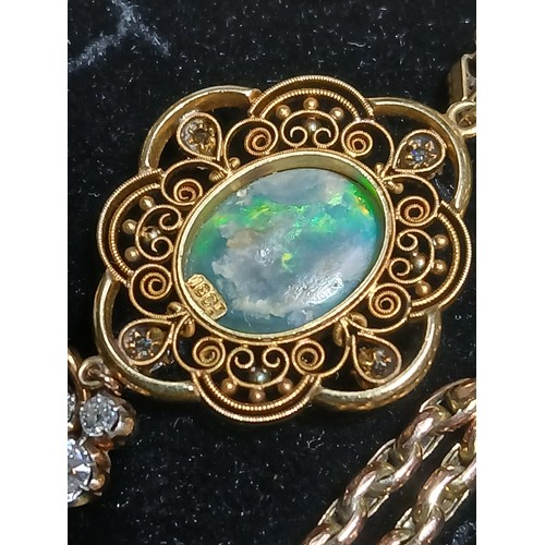 3 - An antique black opal and diamond pendant, the central millegrain set opal cabochon measuring approx... 