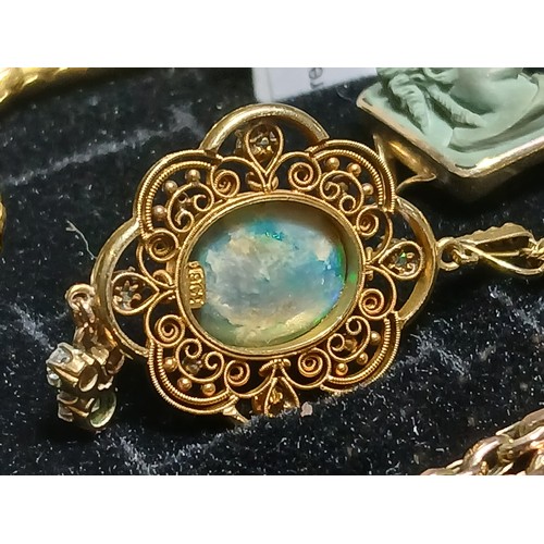 3 - An antique black opal and diamond pendant, the central millegrain set opal cabochon measuring approx... 