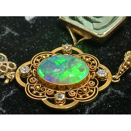 3 - An antique black opal and diamond pendant, the central millegrain set opal cabochon measuring approx... 