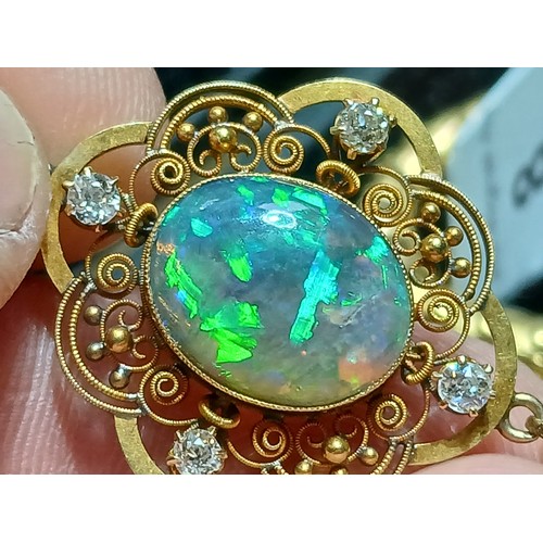 3 - An antique black opal and diamond pendant, the central millegrain set opal cabochon measuring approx... 