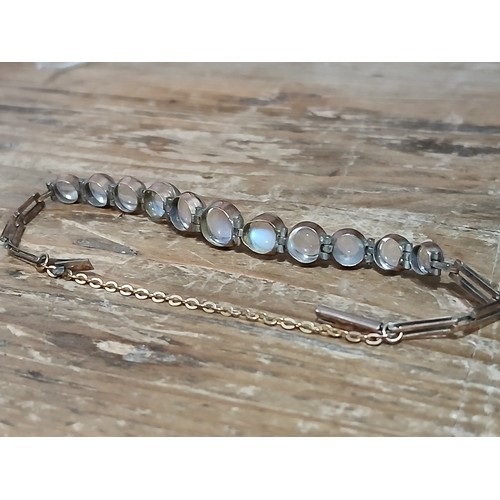 61 - An antique yellow metal moonstone cabochon bracelet, unmarked, length 15cm, gross weight 4.9g.