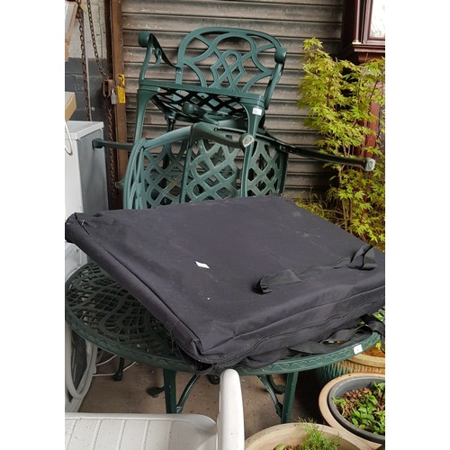 16 - 2 Metal garden tables and 4 chairs together with 2 garden loungers in carry bags