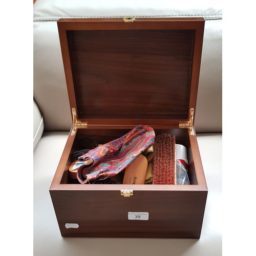 35 - A Russell & Bromley shoe care kit in wood case with brass fittings.