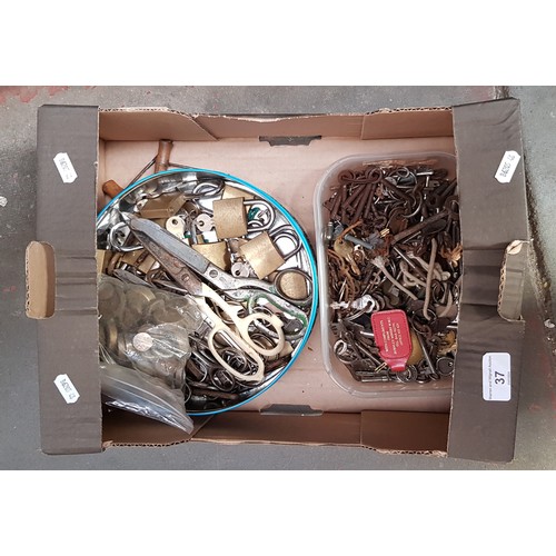 37 - A box of mixed metalware including cabinet keys, clock keys, padlocks with keys, scissors and bottle... 