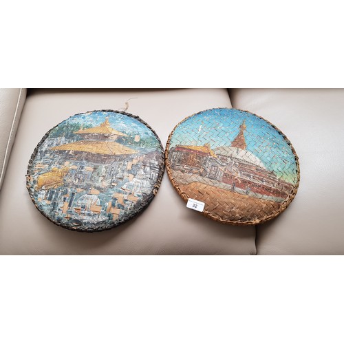32 - Two painted woven basket lids painted with images of temples