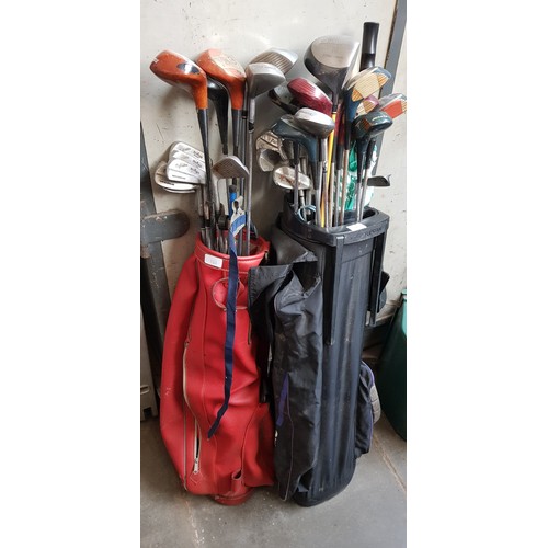 121 - 2 golf bags containing a large number of clubs