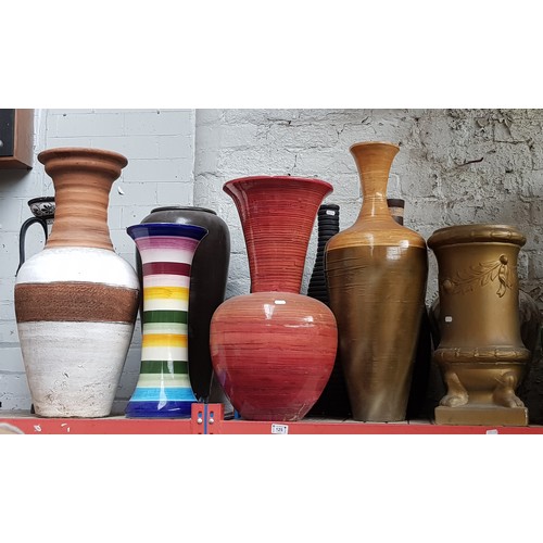 125 - A collection of pottery and wooden vases.