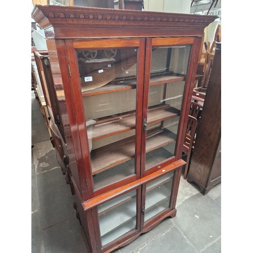 911 - An Edwardian glazed cabinet bookcase.