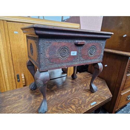 907 - An eastern carved hardwood box stool.