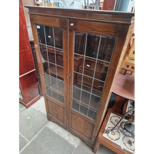 912 - An oak leaded glass bookcase.