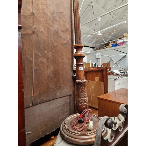 913 - A carved and stained beech standard lamp.