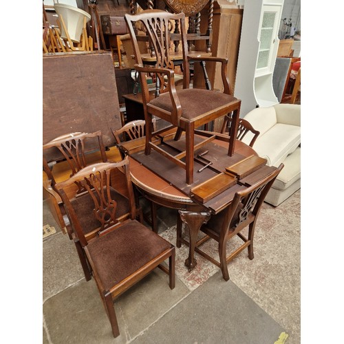 954 - An early 20th century mahogany oval extending dining table and six Georgian style chairs.