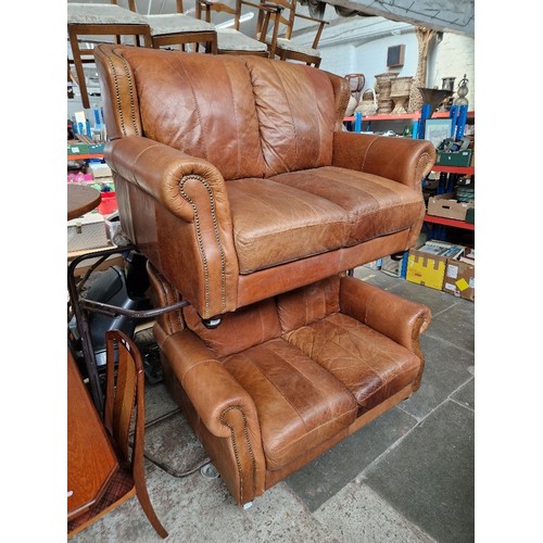 959 - A pair of tan leather settees.