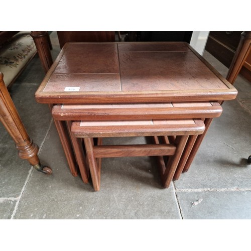 939 - A mid 20th century tile top teak nest of tables.