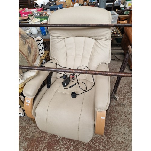 957 - A light grey leather electric reclining and swivel lounge chair.