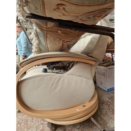 957 - A light grey leather electric reclining and swivel lounge chair.