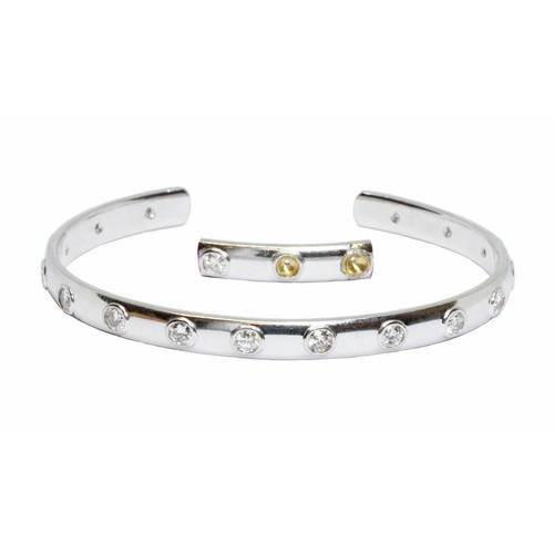 3 - DAVID BURNS: an 18ct white gold diamond bangle, sixteen round brilliant cut diamonds weighing approx... 