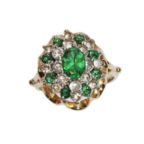 22 - A hallmarked 9ct gold cluster ring, set with a central soude green stone, green GTDs and colourless ... 