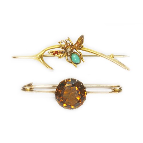 27 - Two antique brooches: one modelled as a wishbone and mounted with a butterfly and the other set with... 