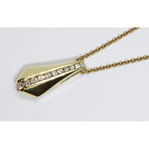 17 - CARTIER/MAYORS: an 18ct yellow gold diamond pendant on chain, the pendant with channel set round bri... 