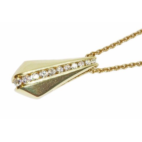 17 - CARTIER/MAYORS: an 18ct yellow gold diamond pendant on chain, the pendant with channel set round bri... 