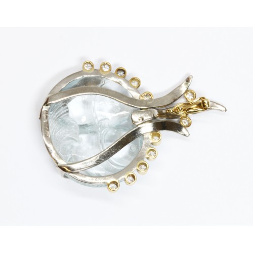 16 - An 18ct gold aquamarine and diamond pendant, the carved aquamarine cabochon modelled as two fish, tw... 