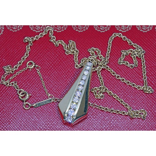 17 - CARTIER/MAYORS: an 18ct yellow gold diamond pendant on chain, the pendant with channel set round bri... 