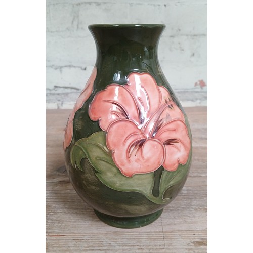 425 - A Moorcroft pottery green ground vase, height 20cm.