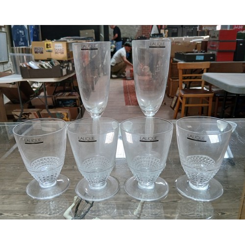 420 - A group of six Lalique drinking glasses comprising four tumblers and two champagne flutes.