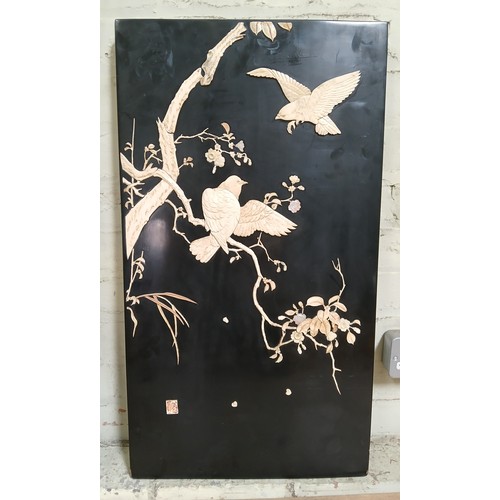 436 - A Japanese carved bone, mother of pearl and black lacquer panel 42cm x 76cm.