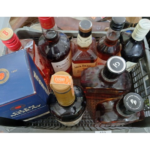 483 - Nine bottles of alcohol, mainly whisky and bourbon.