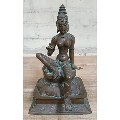 460 - An Indian cast brass deity, height 23.5cm.