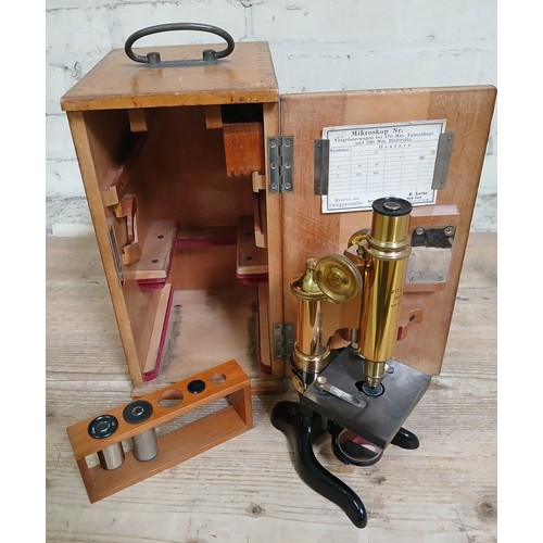 468 - A Leitz brass microscope, boxed with accessories.