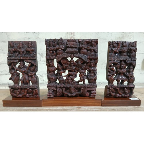 463 - A group of three Indian carved hardwood temple carvings, mounted on bases, tallest 29cm.