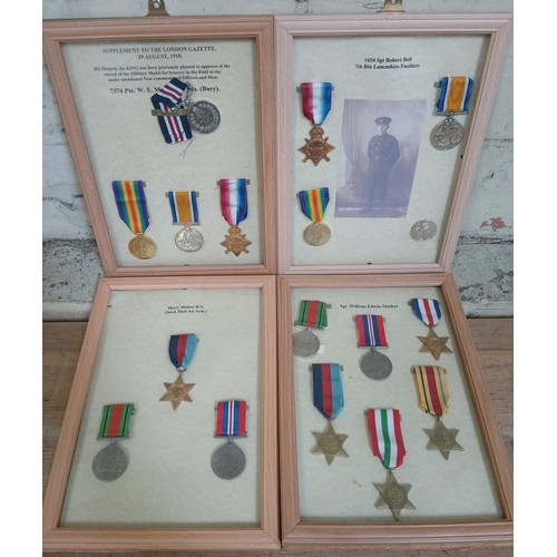 454 - Four sets of framed WWI and WWII medals, all re-strikes.