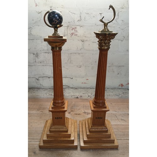 492 - A pair of Masonic light oak and brass mounted corinthian columns with terrestrial globes to top (one... 